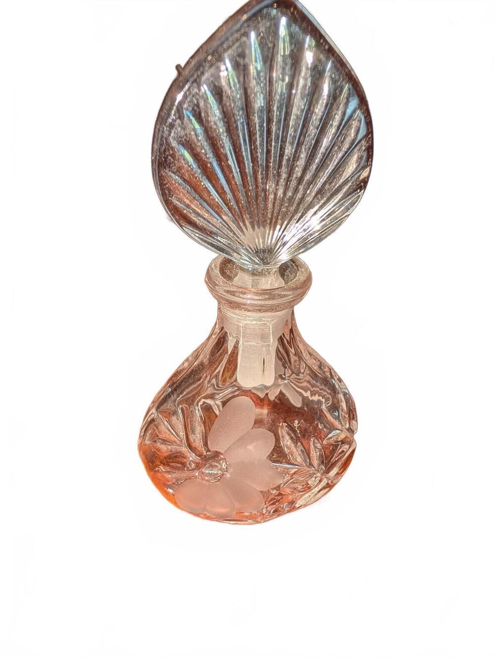 Vintage Clear Glass Perfume Bottle with Leaf Stopper table behind is brown